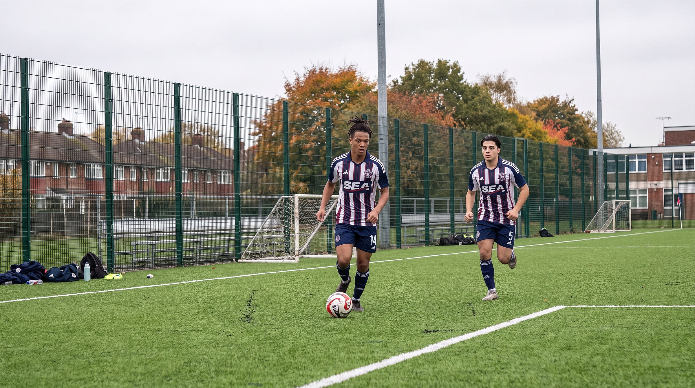 Gabriel Costa (#14) on the ball with Omar Khalil (#5) chasing in training on the turf